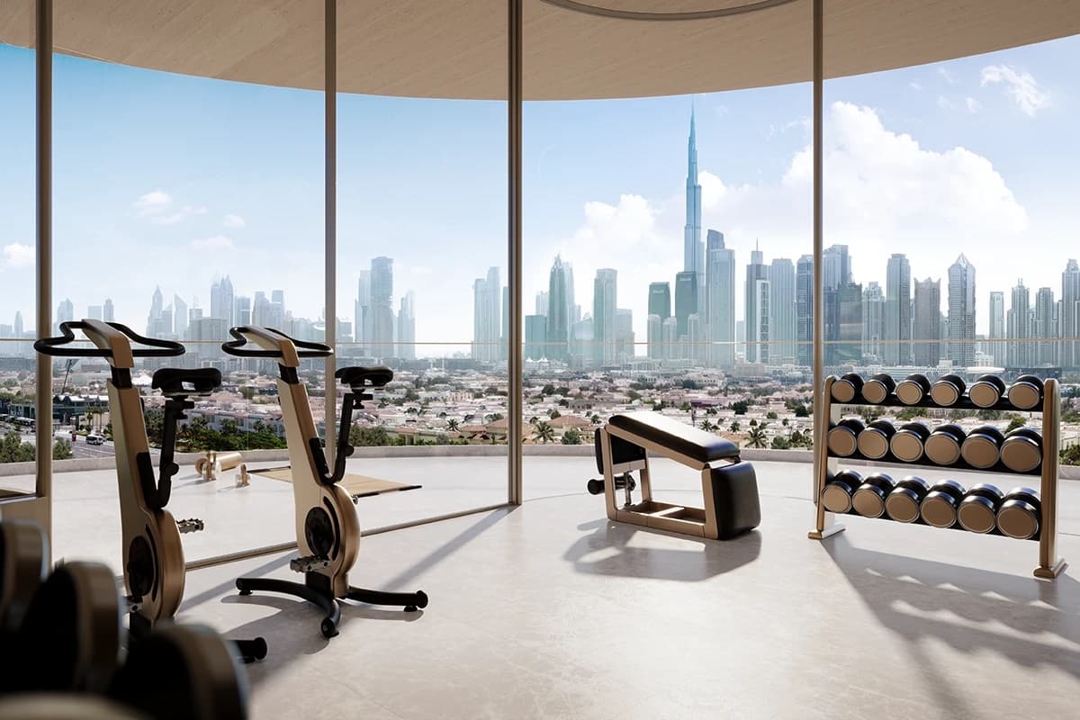 Private gym with floor-to-ceiling windows facing the Downtown Dubai skyline