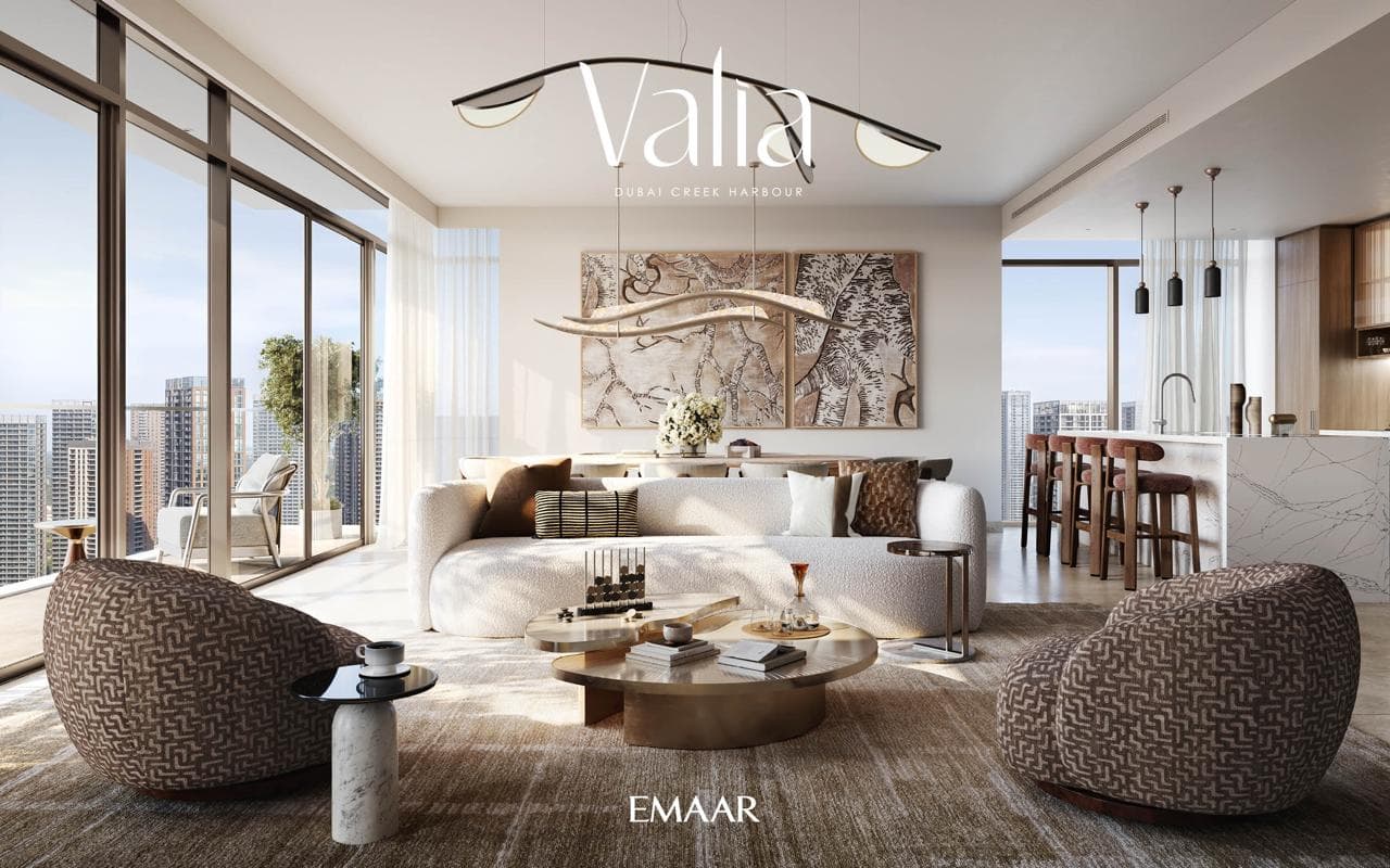 Furnished open-plan living and kitchen area in a Valia apartment with floor-to-ceiling city views